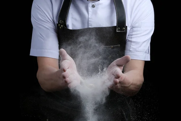 hand clap of chef with flour on black background isolated