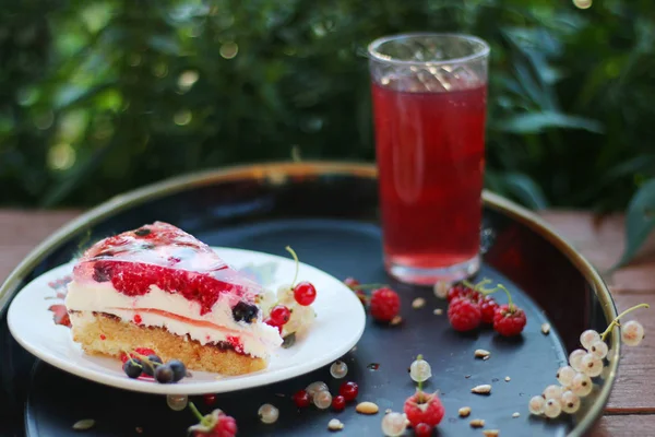 summer cake with berries with flowers and grass background