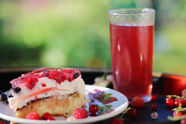 summer cake with berries with flowers and grass background