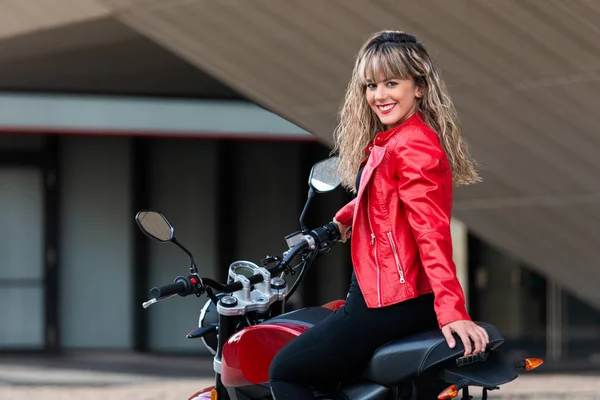 Young beautiful woman on motorcycle looking back