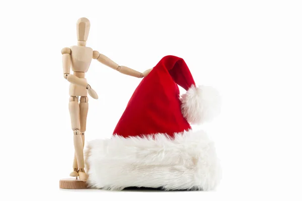 Figura de juguete de madera con un sombrero rojo de Santa Claus sobre fondo blanco — Foto de Stock