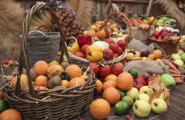 Collection of fall fruits and vegetables in baskets on display. Autumn nature concept. Thanksgiving dinner.