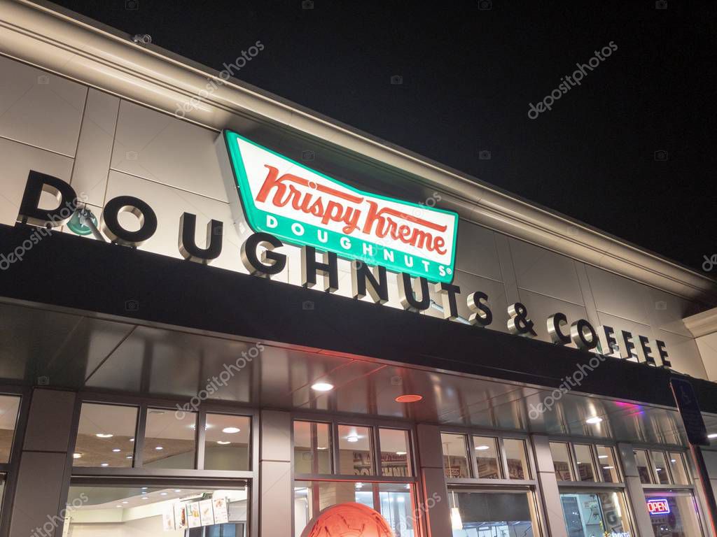 Portland, Ore - March 24 2019: Krispy Kreme Doughnuts storefront at night.