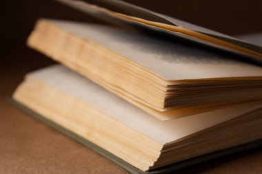 Kahverengi arka planla ilgili eski bir kitap Karanlıkta yakın plan