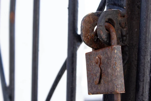 Old rusty lock on a metal gate