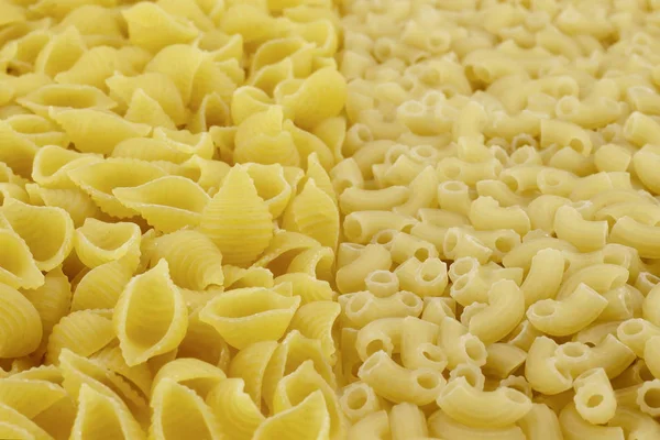 Two kinds of pasta.The foreground in focus, back is not present.