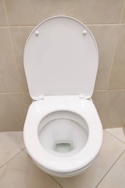 White toilet. Closeup of the white toilet with open cover Stock Photo