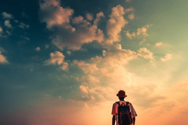 man with backpack and looking beautiful sky in sunset. concept for adventure and travel  in summer vacations and outdoor alonePhang Nga,Koh Yao Yai,Thailand clipart