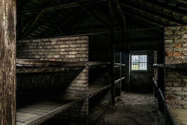 Sleeping quarters with wooden bunk beds showing prisoners terrible living conditions  at The Nazi concentration camp of birkenau in Oswiecim, Poland, a UNESCO World Heritage.