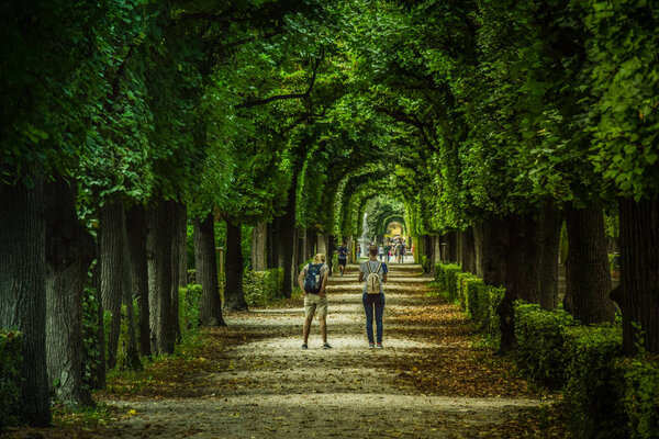 Vienna, Austria, September , 15, 2019 - : Tourists walking at the gardens of Schonbrunn Palace , a former imperial summer residence of Habsburg monarchs