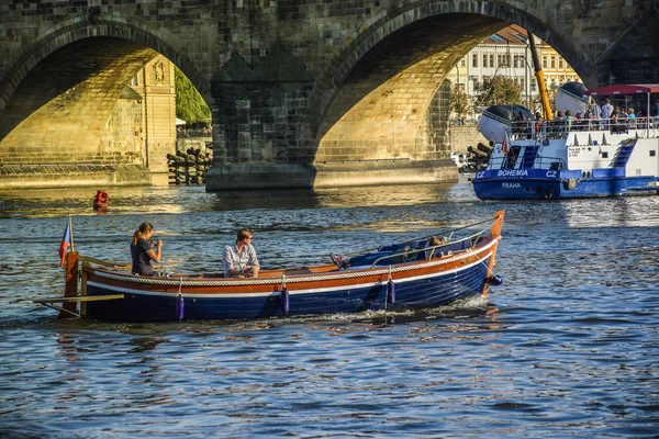 Praga, Repubblica Ceca - 17 settembre 2019: La coppia gode di un romantico tramonto in barca nel fiume Moldava vicino al ponte Carlo e al castello di Praga — Foto Stock