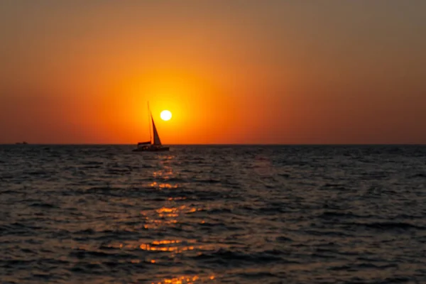 Samotna Żaglówka Zachodzie Słońca Atmosferyczny Pejzaż Morski Pomarańczowym Słońcem Bezchmurne — Zdjęcie stockowe