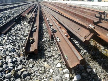 Gevşek tren rayları birikmiş. İspanyol demiryolu ekipmanlarının onarımı ve bakımı için demir parçaları.