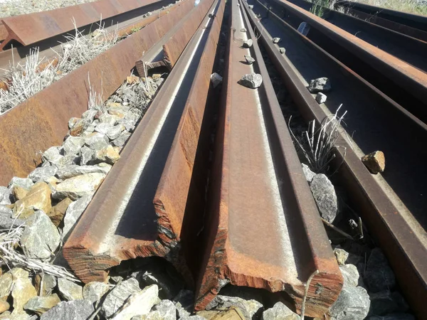 Loose train tracks piled up. Pieces of sections of iron for repairs and maintenance of Spanish railway equipment.