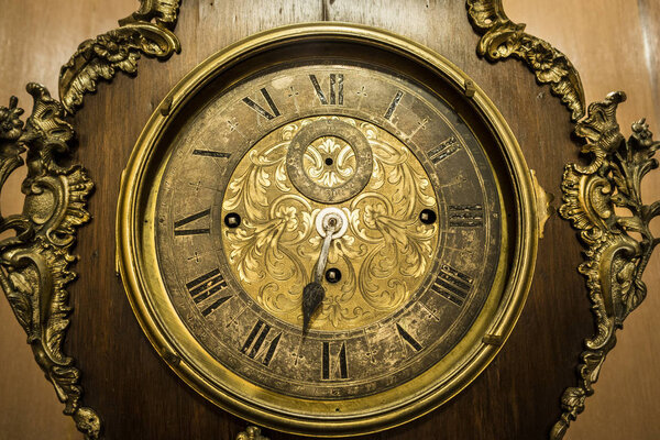 old gold and bronze broken standing clock close up