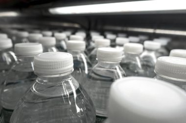 white cap bottled water market display or assembly line  