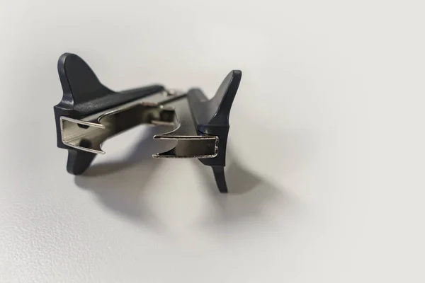 black and silver plastic and metal staple remover