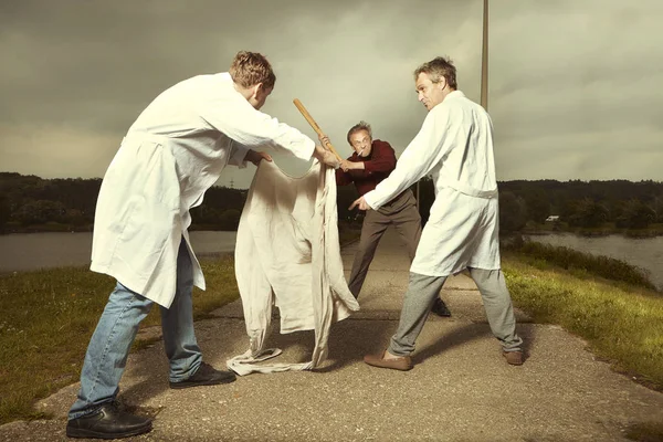 Two Older Retro Paramedic Freak Hunters Medical Coats Fighting Crazy — Stock Photo, Image