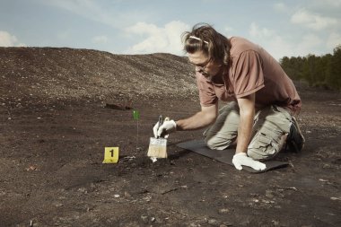 Uncovering of old human grave and skull on summer terrain excavations on field location clipart