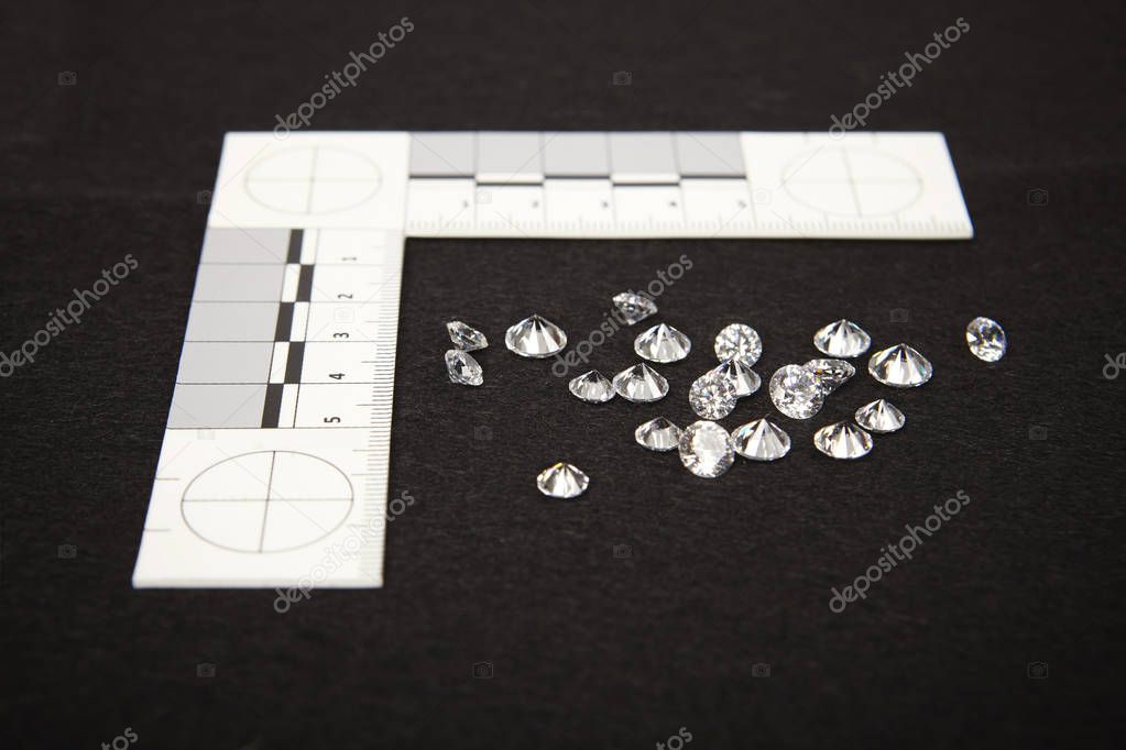 Seized contraband of smuggled diamonds documented by police authority with metric scale