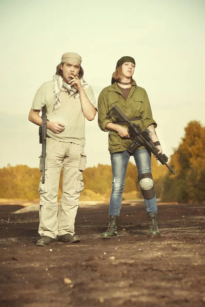 Guerilla, partisan or territory army couple watching around armed with guns