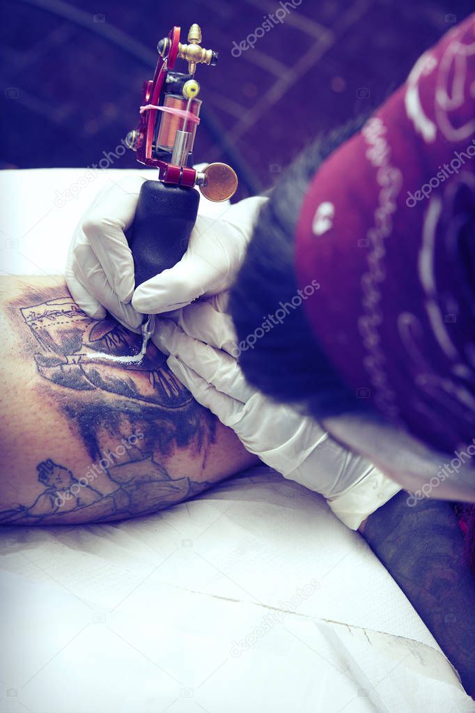 Session of tattooing in studio during making picture on calf