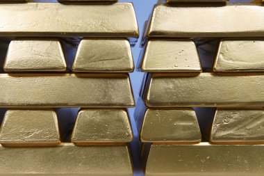 Hundreds kilos of illegal gold bullions on background clipart