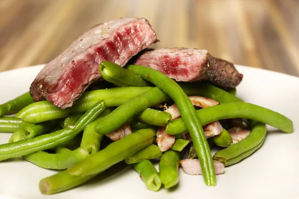 Yeşil fasulye, sarımsak ve işaret ile lezzetli sığır biftek