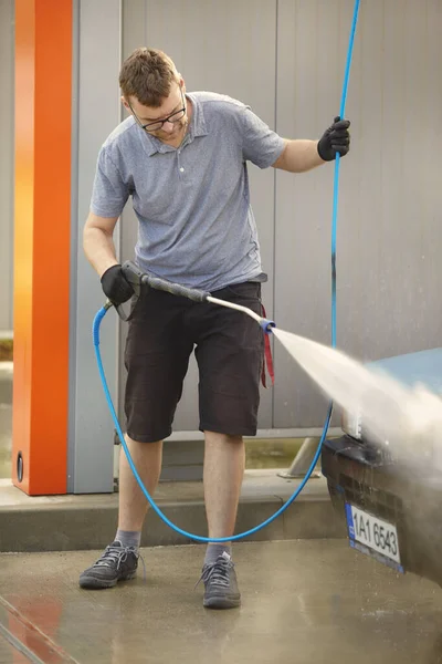 Man in car wash take care of his lovely retro car