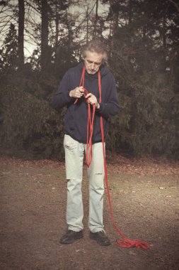 Lonely old man thinking of possibility of suicide in city park