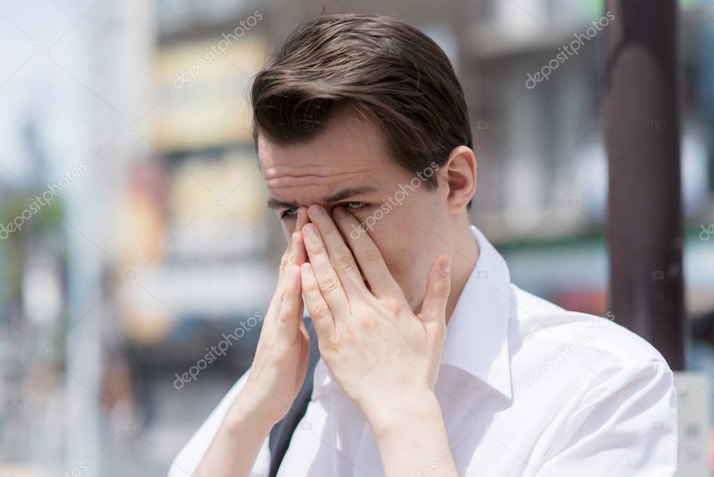 A young man has Itchy, watery, swollen eyes due to pollen allerg