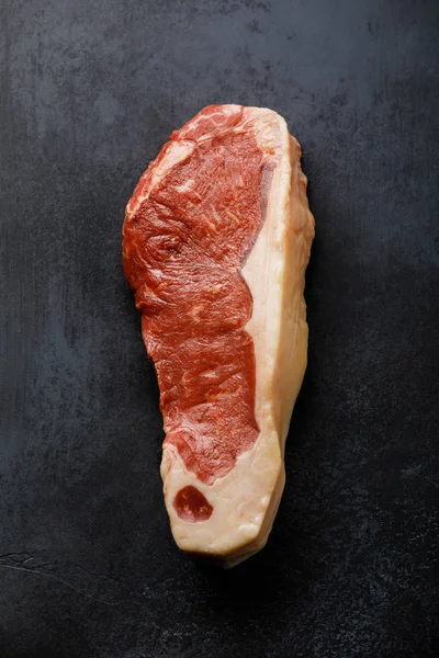 Raw Black Angus Prime meat steak Striploin on dark background