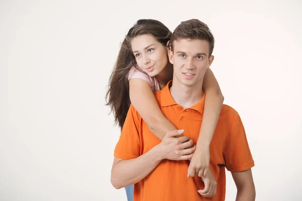 Happy lovely couple hugging and smiling looking at camera on white background — Stock Photo, Image