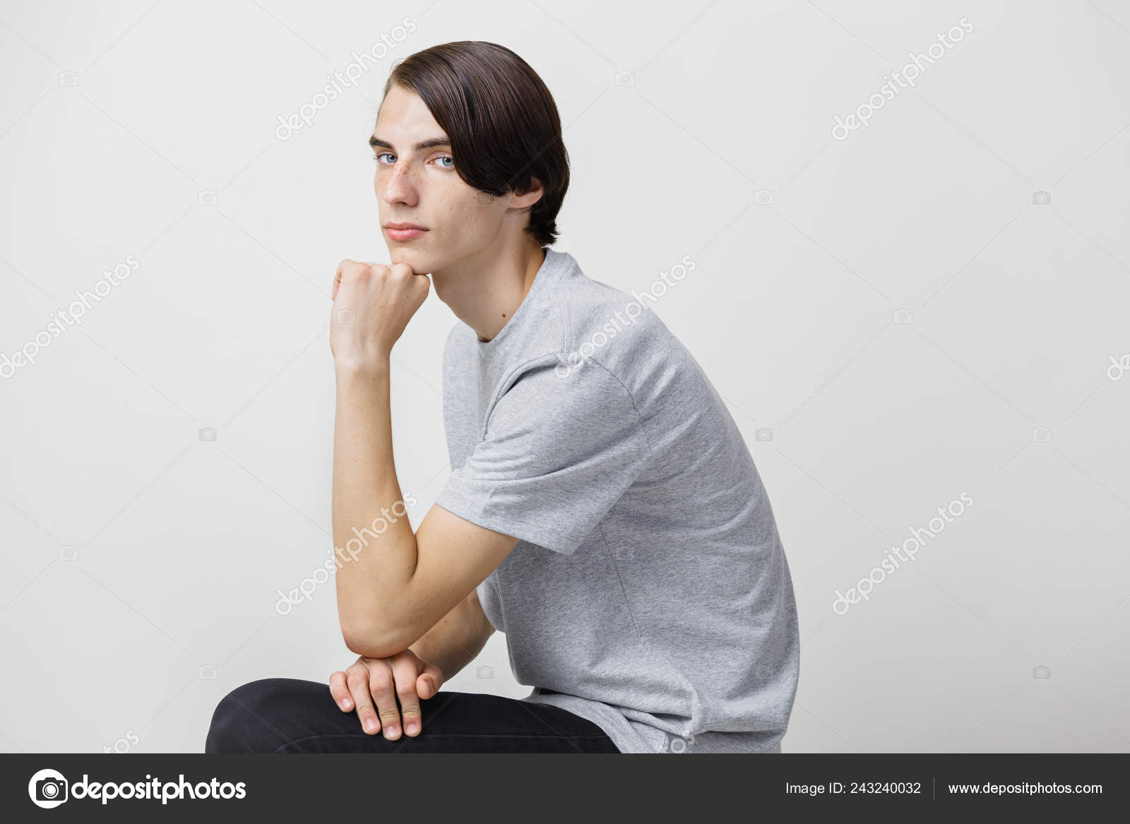 Calm And Relaxed Young Thin Dark Haired Guy With Blue Eyes Wearing