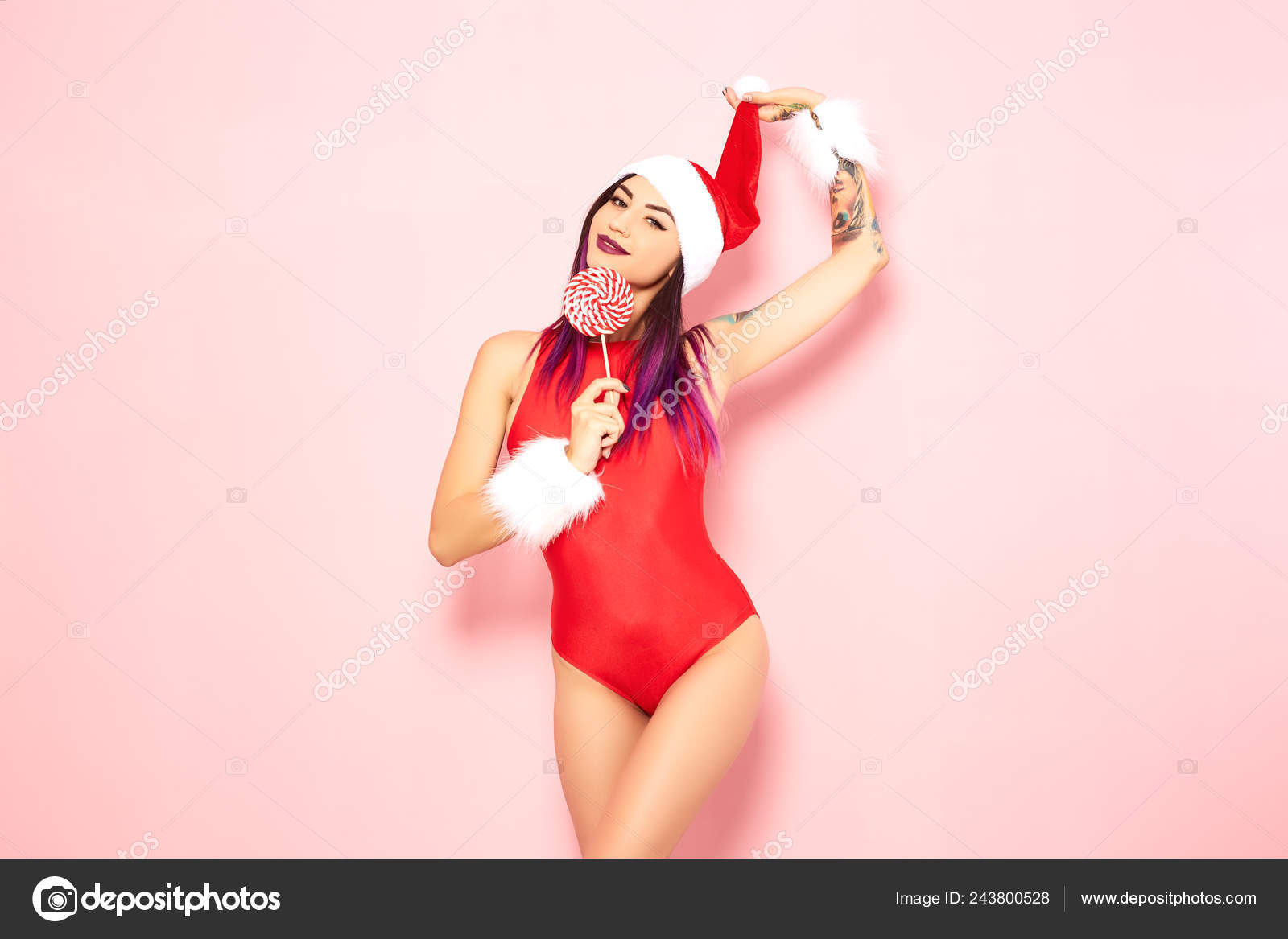 Girl With Purple Hair Tips And Tattoos On Her Arm Dressed In Red