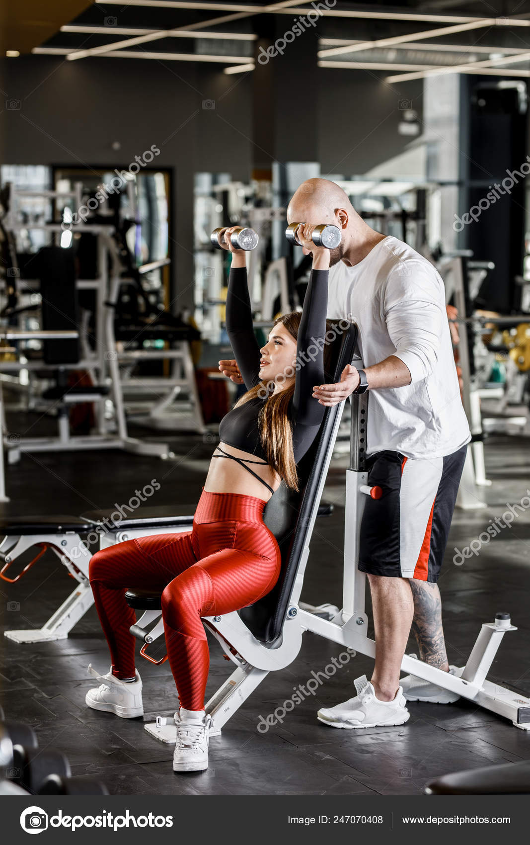 Slender Nice Girl Does A Dumbbell Bench Press Up Sitting On A