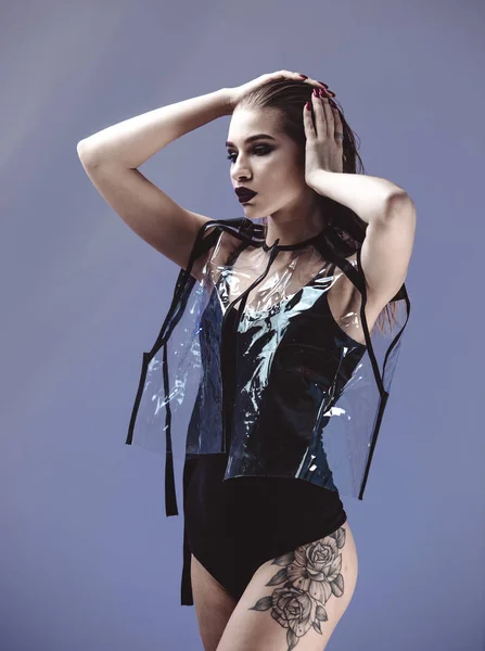 Cryptonanus stijlvolle meisje met nat haar en tattoo op haar been gekleed in zwarte zwemmen pak en transparante jas is poseren op de grijze achtergrond in de studio — Stockfoto