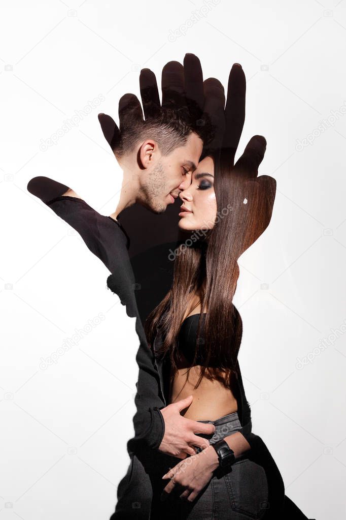Art picture of  embracing guy with a girl, in the shape of hands on white background