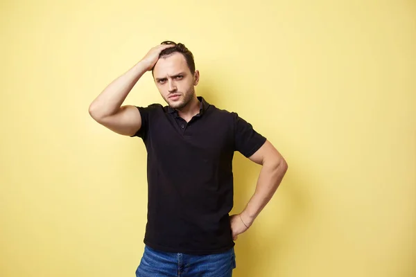 Разочарованный парень в черной футболке — стоковое фото