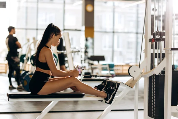 Nice Slim Curly Dark-haired Girl Dressed in Sports Clothes is Sitting on  the Mat for Fitness in the Modern Gym with a Stock Photo - Image of  beautiful, exercise: 144440536