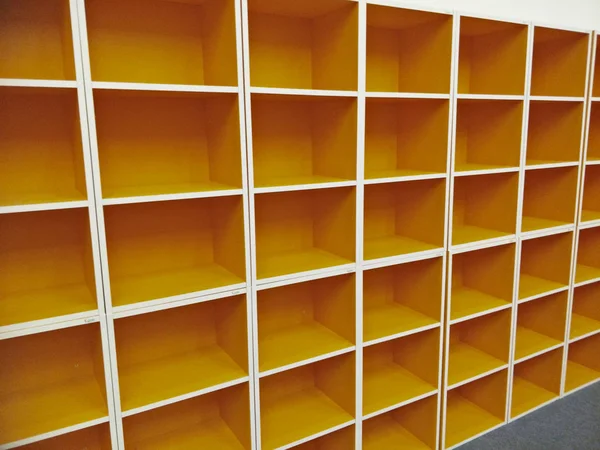 orange bookshelf in the library