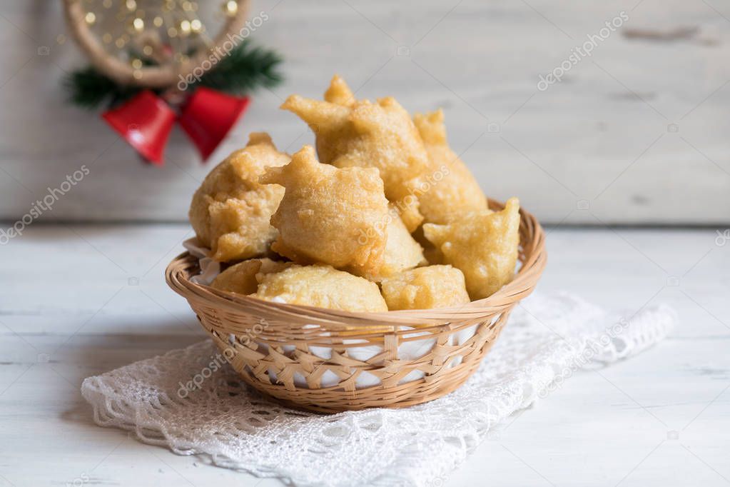 Pettole is a traditional christmas south italian food cooked from dough and fried in olive oil, made in Salento, Apulia