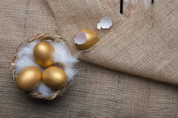 Success Symbol or Happy Easter Concept. Empty Broken Big Golden Egg on a rustic wooden natural background