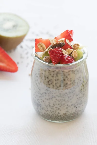 Healthy vegan chia pudding in a jar with fresh berries