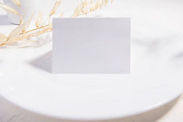 Luxury Mockup template, empty stationery card with dry plants flower and perfume on a white background and design element for wedding invitation, rsvp, thank you card, greeting, business card