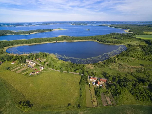 Aerial view of beautiful landscape of lake district, Pniewskie Lake in the foreground, next Mamry Lake and Upalty - the biggest island of Mazury region, Poland