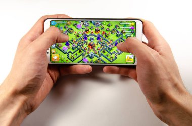 Nisan, 2019. Kramatorsk, Ukrayna. Klan oyun elinde beyaz bir smartphone üzerinde çatışması
