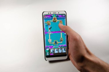 Nisan, 2019. Kramatorsk, Ukrayna. Royale oyun üzerinde beyaz bir akıllı telefon elinde çatışma