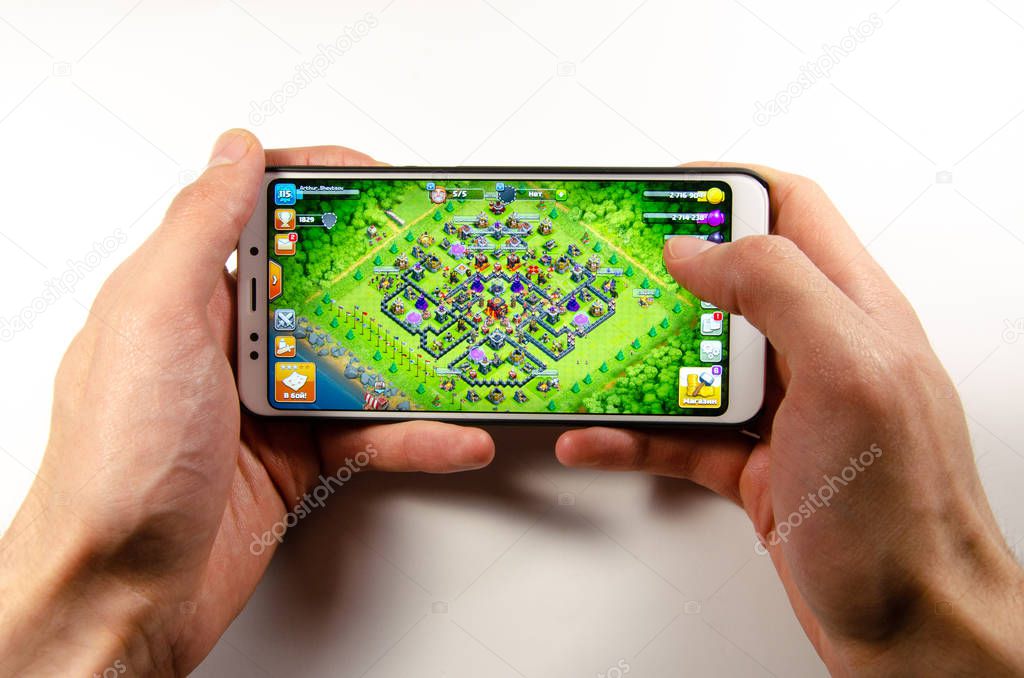 April, 2019. Kramatorsk, Ukraine. Clash of Clans gameplay on a white smartphone in hand