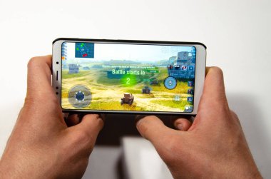 Nisan 2019. San Francisco, ABD. Eller bir akıllı telefon tutarak hangi oyun, Oyunlar Dünya Tankları Blitz oynanışı